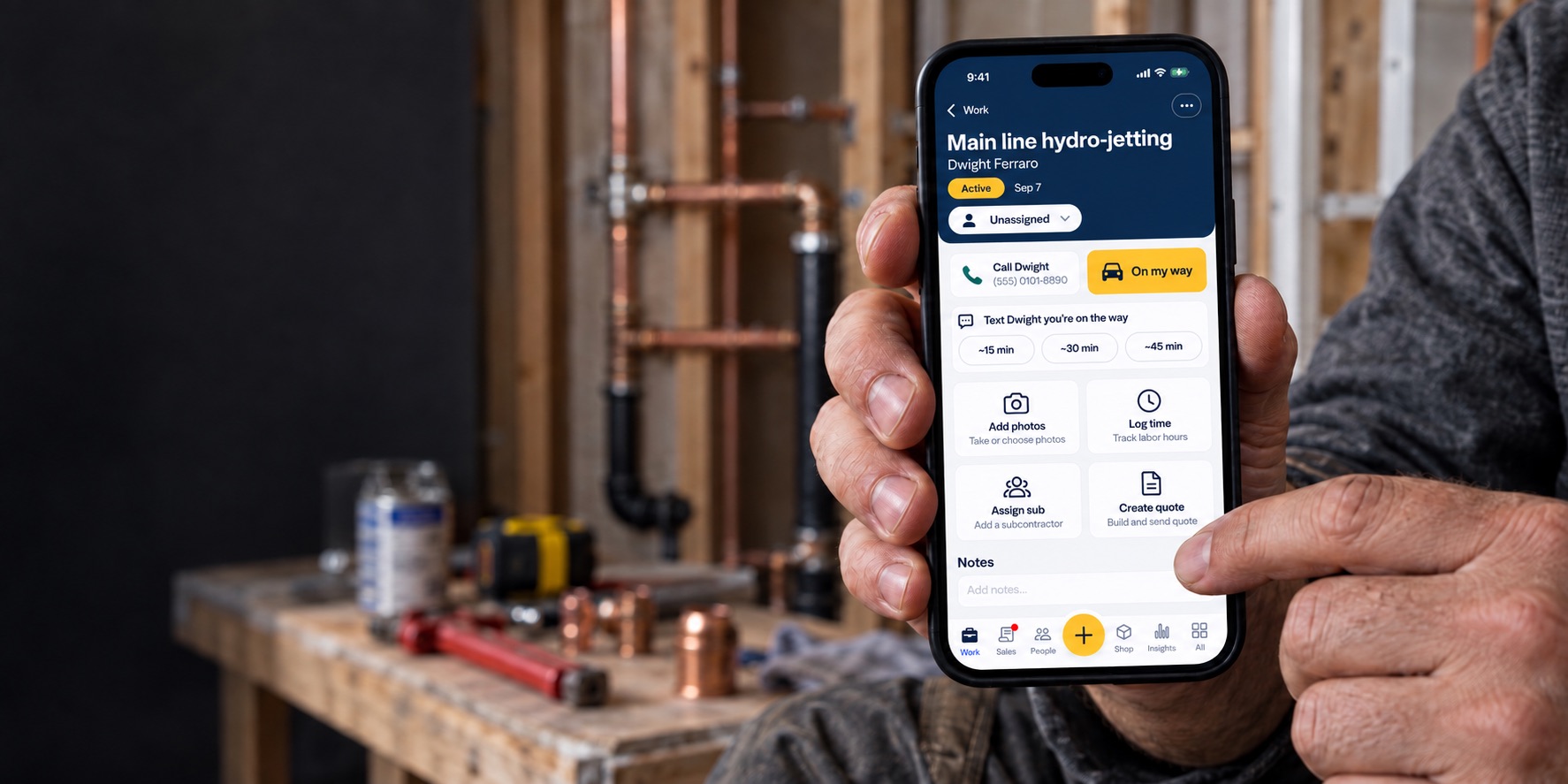 Tradesperson using FieldNari’s job-details screen at an indoor plumbing renovation